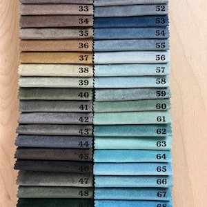 May include: A fabric swatch card with 20 different fabric samples in various shades of brown, blue, green, and gray. The swatches are numbered from 33 to 51 on the left side and 52 to 70 on the right side. The card is labeled "Atelier Sp&eacute;cially Made".