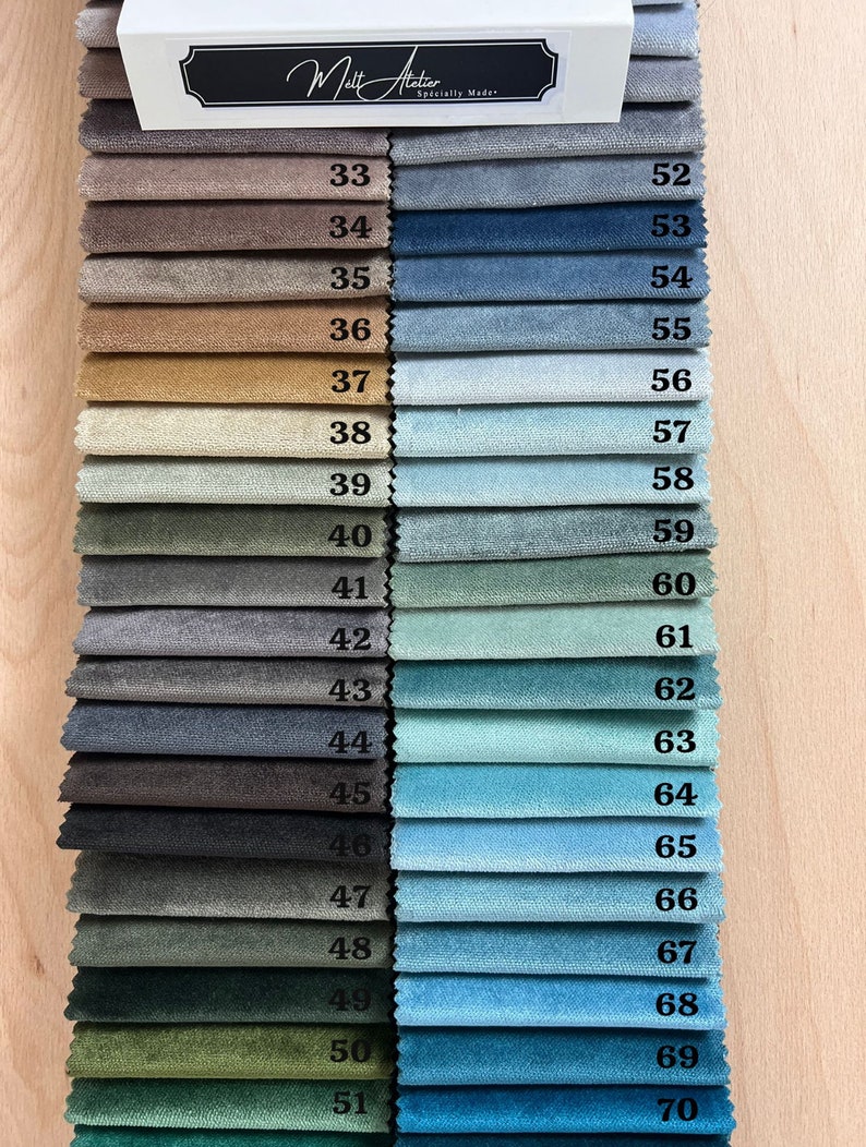 May include: A fabric swatch card with 20 different fabric samples in various shades of brown, blue, green, and gray. The swatches are numbered from 33 to 51 on the left side and 52 to 70 on the right side. The card is labeled "Atelier Sp&eacute;cially Made".