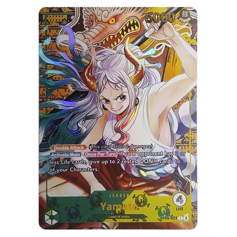 Pode incluir: Um cart&atilde;o de troca com um personagem do anime One Piece. O personagem &eacute; Yamato, um l&iacute;der com um valor de vida de 4. O cart&atilde;o tem um fundo dourado e verde com um design de drag&atilde;o. O texto do cart&atilde;o diz "Ataque Duplo Este cart&atilde;o causa 2 de dano Ativar: Principal Uma vez por turno Se o seu oponente tiver 3 ou menos cartas de Vida, ceda at&eacute; 2 cartas DON!! descansadas para 1 de seus personagens."