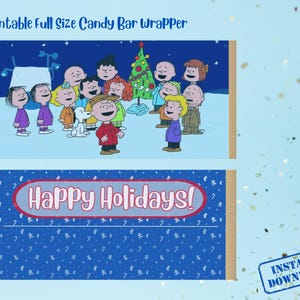 May include: Printable candy bar wrapper featuring a cartoon scene with children and a Christmas tree. The top section shows a winter scene with characters. The bottom section has a blue background with the text "Happy Holidays!"