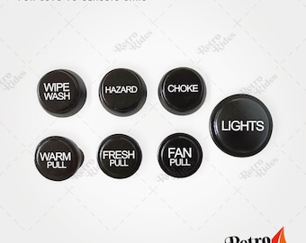 May include: Set of seven black plastic dashboard knobs with white lettering. The knobs are labeled "Wipe Wash", "Hazard", "Choke", "Lights", "Warm Pull", "Fresh Pull", and "Fan Pull".