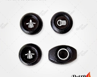 May include: Four black dashboard knobs with white markings for classic cars. The knobs are for 1979-85 vehicles.