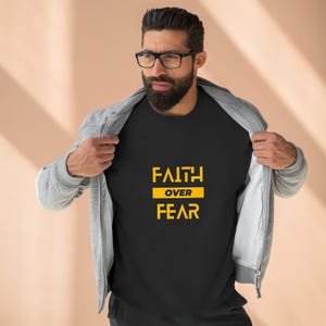 May include: Black t-shirt with the text "FAITH OVER FEAR" in yellow.