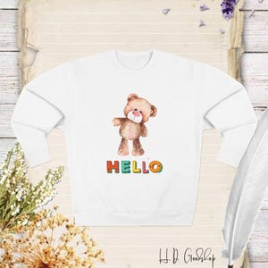 Say Hello to Cozy Comfort with Our Adorable Teddy Bear Sweatshirt Featuring the Warm Greeting 'Hello' !