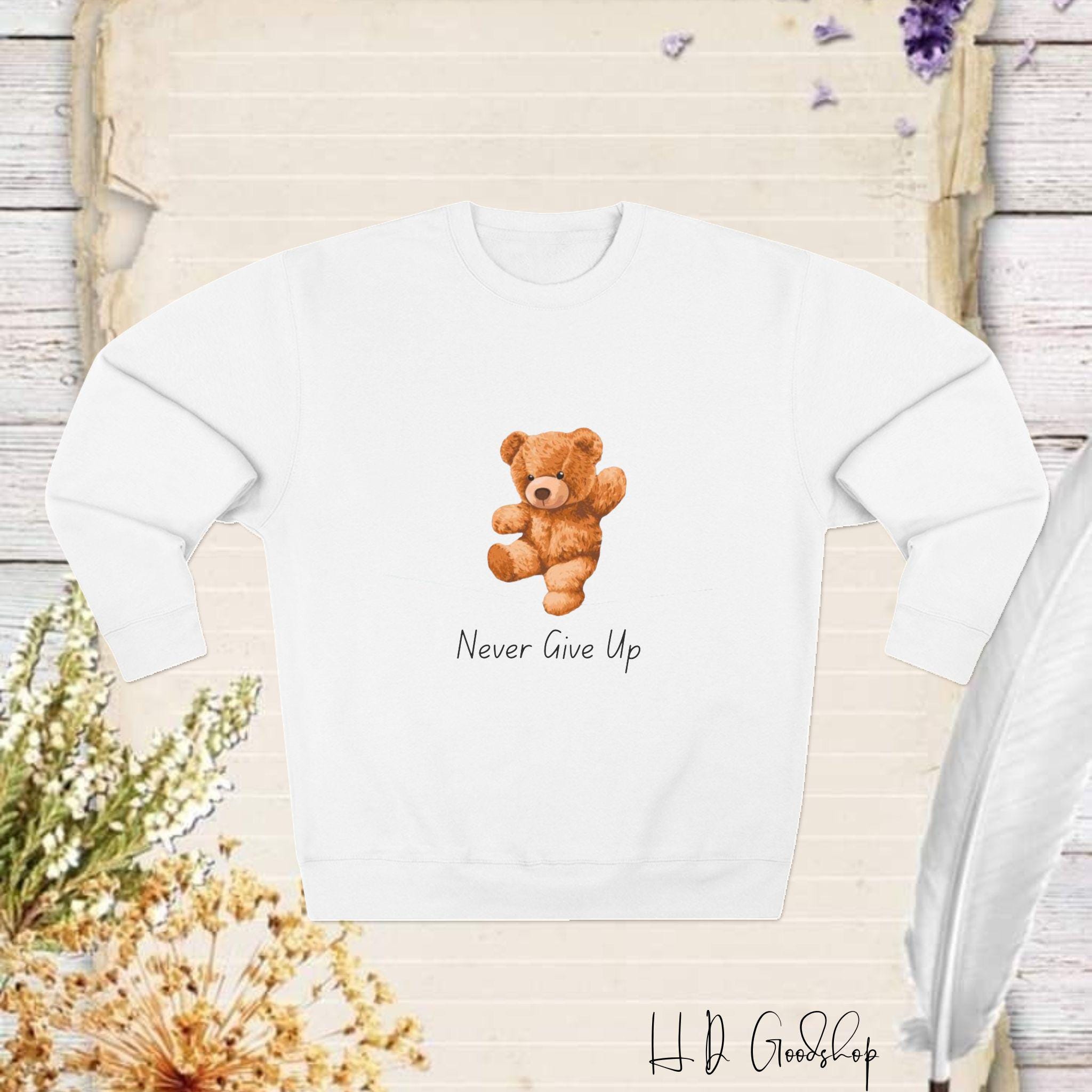Embrace Perseverance: 'Never Give Up' Teddy Bear Sweatshirt - A Heartwarming Reminder to Stay Strong and Keep Going, No Matter the Challenge