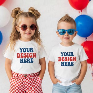 May include: Two children wearing white t-shirts with the text "YOUR DESIGN HERE" in red and blue. One child wears red-tinted sunglasses and red and white checkered shorts. The other child wears blue sunglasses and blue jeans. Red, white, and blue balloons are in the background.