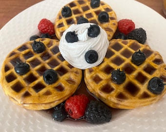 Faux waffles with syrup, whipped cream and fruit