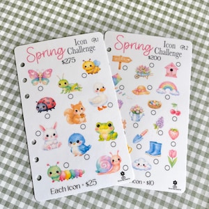 May include: Two white cards with a spring theme, featuring colorful illustrations of butterflies, bees, and other spring icons. The cards have the text "Spring Challenge" and include circles for tracking. The background is a green and white checkered pattern.