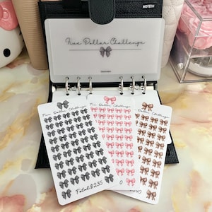 May include: Three sheets of stickers with a variety of bows in black, pink, and brown. The stickers are labeled "Five Dollar Challenge" and the total cost is $235.