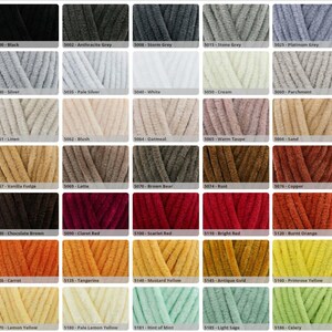 May include: A colour chart featuring forty swatches of plush, velvet-textured yarn. Each square displays a unique colour ranging from black, greys, and whites to earthy browns, reds, oranges, yellows, and greens, each labelled with a code and name.