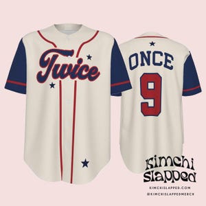 May include: Cream-colored baseball jersey with navy blue sleeves and red accents. The front features the word "Twice" in a script font, and the back displays "ONCE" above the number "9". Small star graphics are also present.