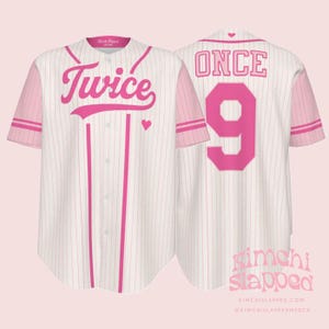 May include: White and pink baseball jersey with the word "Twice" in pink script on the front, along with a pink heart. The back of the jersey has the word "ONCE" and the number "9" in pink. The sleeves are pink.