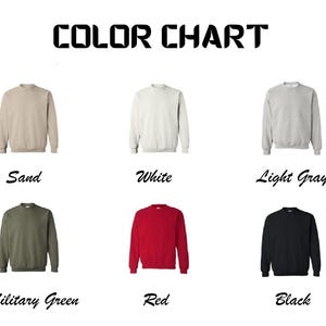 May include: Color chart showing different sweatshirt colors: sand, white, light gray, military green, red, and black.