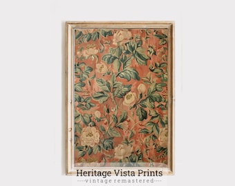 May include: A framed print of a vintage floral pattern with a peach background and green leaves. The print features a repeating pattern of white flowers and green leaves. The frame is a light wood colour.