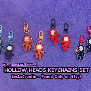 Pode incluir: Um conjunto de oito porta-chaves de acrílico com figuras de pau com cabeças ocas nas cores azul, laranja, vermelho e azul escuro. Cada porta-chaves tem um fecho mosquetão a condizer. Texto: Alan Becker Fanart! HOLLOW HEADS KEYCHAINS SET SocksCreatio - Found Only on Etsy!