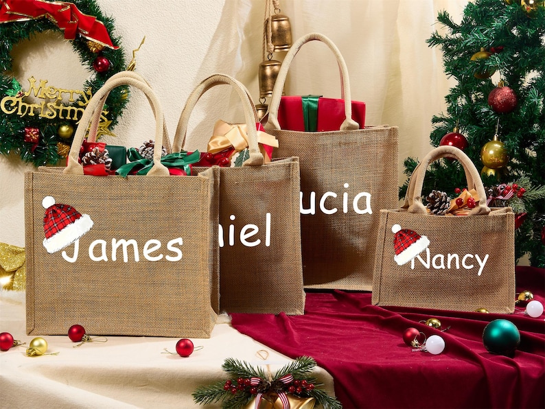 May include: Four burlap tote bags with white text and Christmas decorations. Each bag has a name: James, Daniel, Lucia, and Nancy. The bags are filled with gifts and are decorated with a Santa hat.