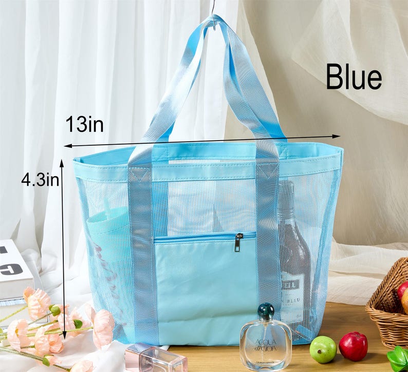 May include: A light blue mesh tote bag with a solid blue pocket and handles. The bag is 13 inches wide and 4.3 inches tall. The word "Blue" is visible on the right side of the bag.