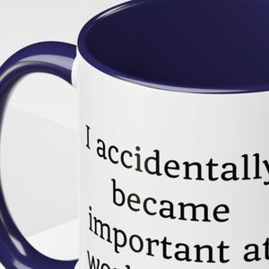 May include: A set of three ceramic mugs with a speckled, cream-colored glaze. Each mug features a different hand-painted design: a blue and green leaf, a yellow flower, and a red berry. The mugs have a simple, rounded shape.