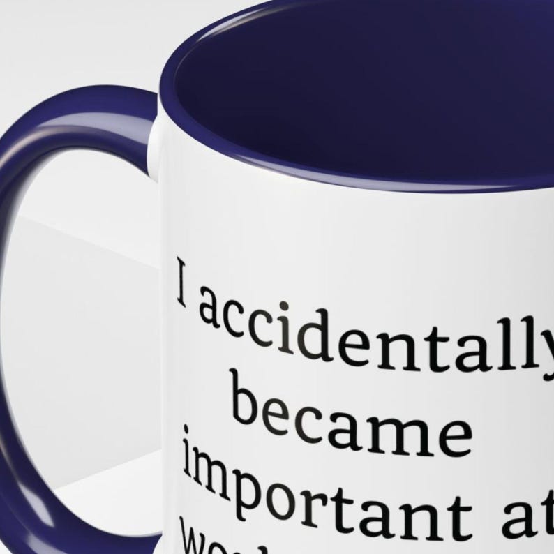 May include: A set of three ceramic mugs with a speckled, cream-colored glaze. Each mug features a different hand-painted design: a blue and green leaf, a yellow flower, and a red berry. The mugs have a simple, rounded shape.