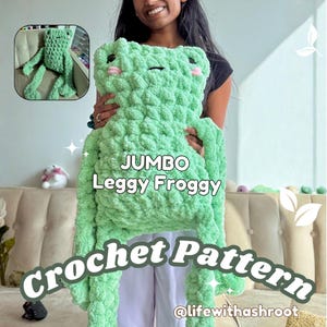 May include: A light green crochet frog plush with long limbs, black eyes, and pink cheeks. The text JUMBO Leggy Froggy Crochet Pattern @lifewithashroot is overlaid on the image, which also includes a small inset showing the frog sitting.