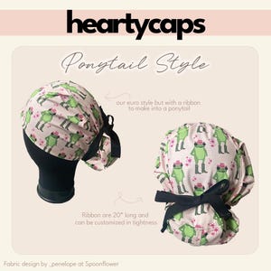 May include: Two pink and green patterned ponytail style scrub caps with a black ribbon. The caps feature a frog design and the text "heartycaps". The ribbon is 50.8 cm long and can be customized.