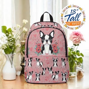 May include: Pink backpack with a Boston Terrier design. The backpack is 18 inches tall and 14 inches wide. The design includes a large Boston Terrier surrounded by flowers, hearts, and paw prints. Additional Boston Terrier illustrations are scattered across the bag.