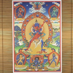 May include: A colorful Tibetan Buddhist painting depicting a deity with multiple arms and legs, surrounded by other figures. The deity is blue and red, with a yellow halo. The painting is on a white background.