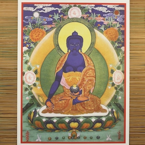 May include: A blue Buddha statue with a yellow robe and a golden halo, sitting on a lotus flower with a green background.