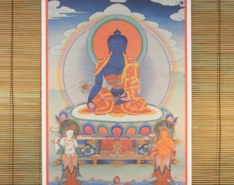 May include: A vibrant, detailed print of a seated blue Buddha figure, adorned with orange and gold robes, set against a backdrop of a rainbow halo and a blue sky with clouds. Two figures flank the central image. The artwork is framed in red.