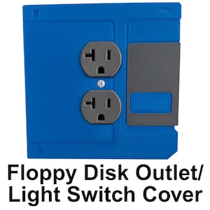 May include: Blue floppy disk-shaped outlet cover with two gray electrical outlets. A gray rectangular piece is on the right side. The text "Floppy Disk Outlet/ Light Switch Cover" is at the bottom.