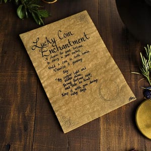 May include: A brown paper scroll with the text "Lucky Coin Enchantment" and instructions on how to use a coin as a charm for good fortune. The text says to hold a coin in both hands, visualise it glowing, and say "By copper light and silver shine, bring fortune near, and fate be kind".