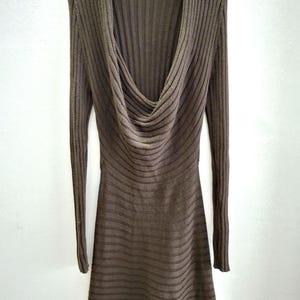 May include: A brown, long-sleeved dress with a cowl neckline. The dress is made of a ribbed knit fabric and hangs on a black hanger. The dress has a fitted bodice and a flared skirt.