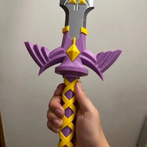 May include: A purple and yellow 3D printed sword with a triangular design on the blade and a braided handle.