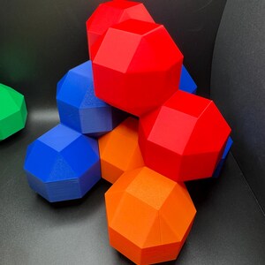 May include: A group of geometric shapes in red, blue, and orange. The shapes are stacked on top of each other, creating a colorful and abstract design.