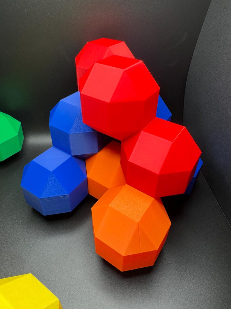 May include: A group of geometric shapes in red, blue, and orange. The shapes are stacked on top of each other, creating a colorful and abstract design.