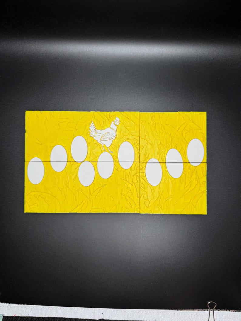 May include: A yellow cardstock with a white chicken and 10 white eggs. The chicken is standing on top of the eggs. The cardstock has a textured pattern.