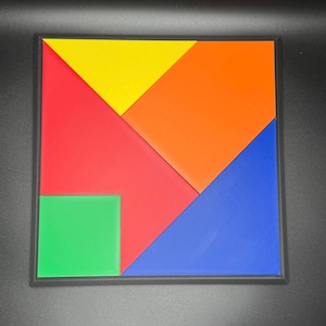 May include: A colorful tangram puzzle with seven pieces in red, orange, yellow, green, and blue. The pieces are arranged to form a square.