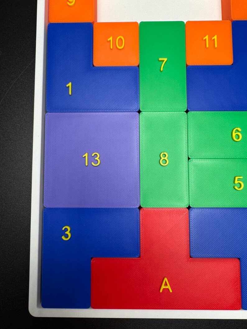 May include: A colorful puzzle with numbered tiles in various colors, including blue, green, red, orange, and purple. The numbers on the tiles range from 1 to 13, with the letter "A" replacing the number 14.