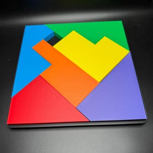 May include: A colorful geometric puzzle made of six pieces. The pieces are arranged in a square shape and are in the colors red, orange, yellow, green, blue, and purple.
