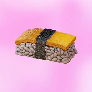 May include: A single piece of sushi with a yellow egg topping, white rice, and a black seaweed wrap.