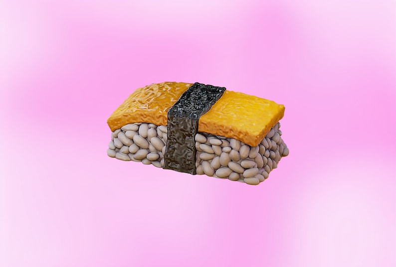 May include: A single piece of sushi with a yellow egg topping, white rice, and a black seaweed wrap.