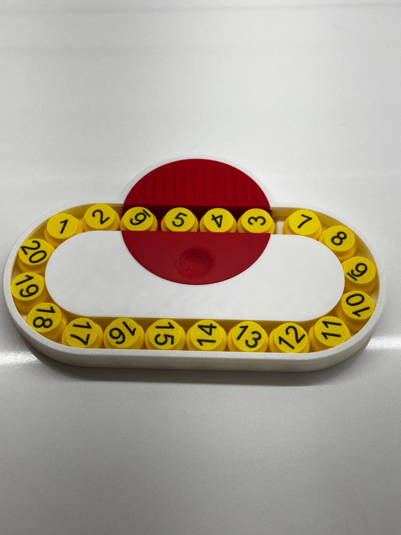 May include: A white plastic circular puzzle with a red center and yellow numbered pieces. The numbers 1 through 20 are displayed on the yellow pieces.