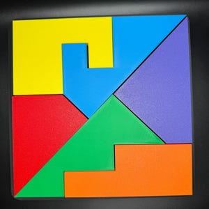 May include: A colorful wooden puzzle with seven pieces in different shapes and colors. The pieces are arranged to form a square. The colors are yellow, blue, green, red, orange, and purple.