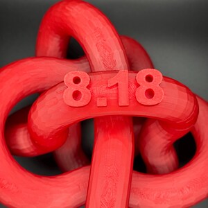 May include: A red plastic knot with the number "818" printed on it.