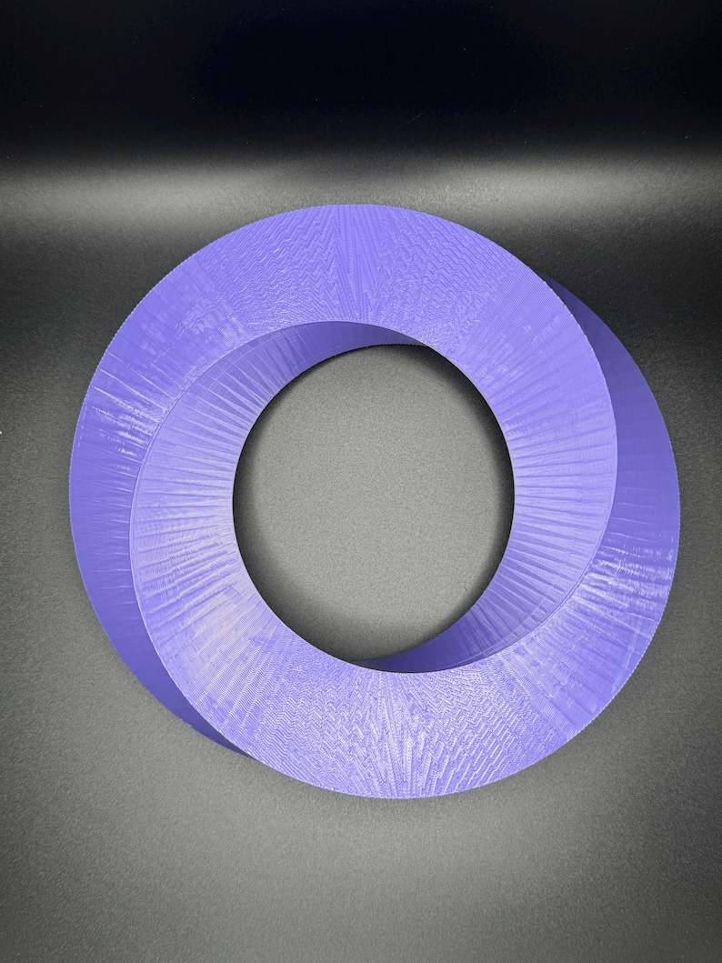 May include: A purple 3D printed Mobius strip, a continuous loop with a twist, creating a single surface with no beginning or end.