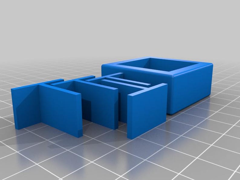 May include: A blue plastic model of the word "TO" in all caps. The letters are stacked on top of each other.