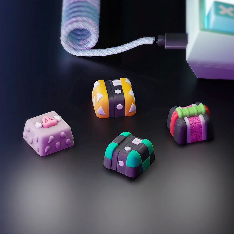 May include: Four colorful keycaps with different designs. The keycaps are made of plastic and have a variety of colors and patterns. The keycaps are designed for mechanical keyboards.