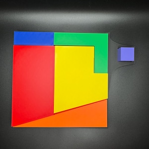 May include: A colorful geometric puzzle with pieces in red, yellow, orange, green, and blue. The puzzle is made of wood and has a simple design.
