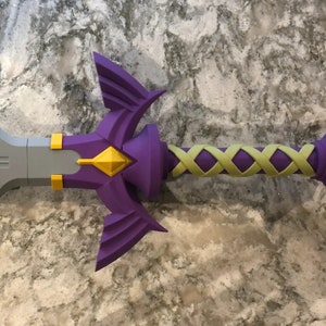 May include: A purple and gold sword with a detailed handle and a triangular design on the blade.