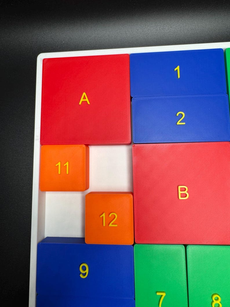 May include: A red, blue, and orange puzzle with numbers and letters. The numbers 1, 2, 9, 11, and 12 are visible. The letters A and B are also visible.